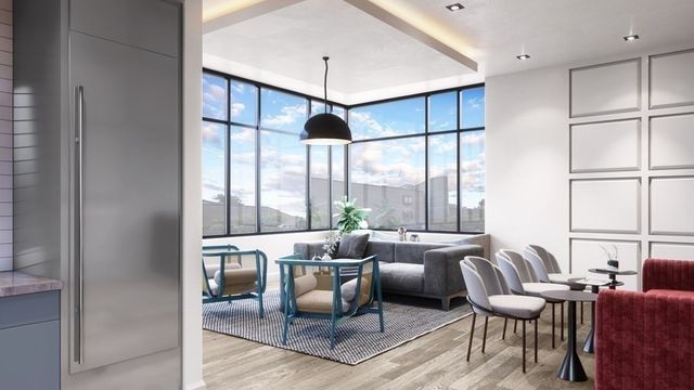 a living room with furniture large window and wooden floor