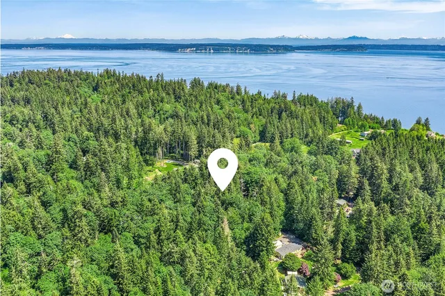 a backyard of a house with lots of green space and outdoor seating