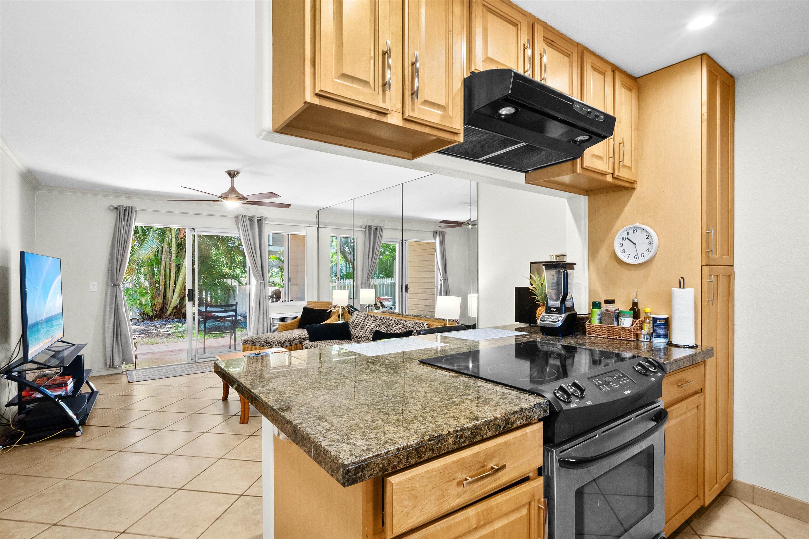 480 Kenolio Road, Unit 15103 Kihei, HI 96753 - Photo 11 of 36 a kitchen with stainless steel appliances granite countertop a stove and a sink