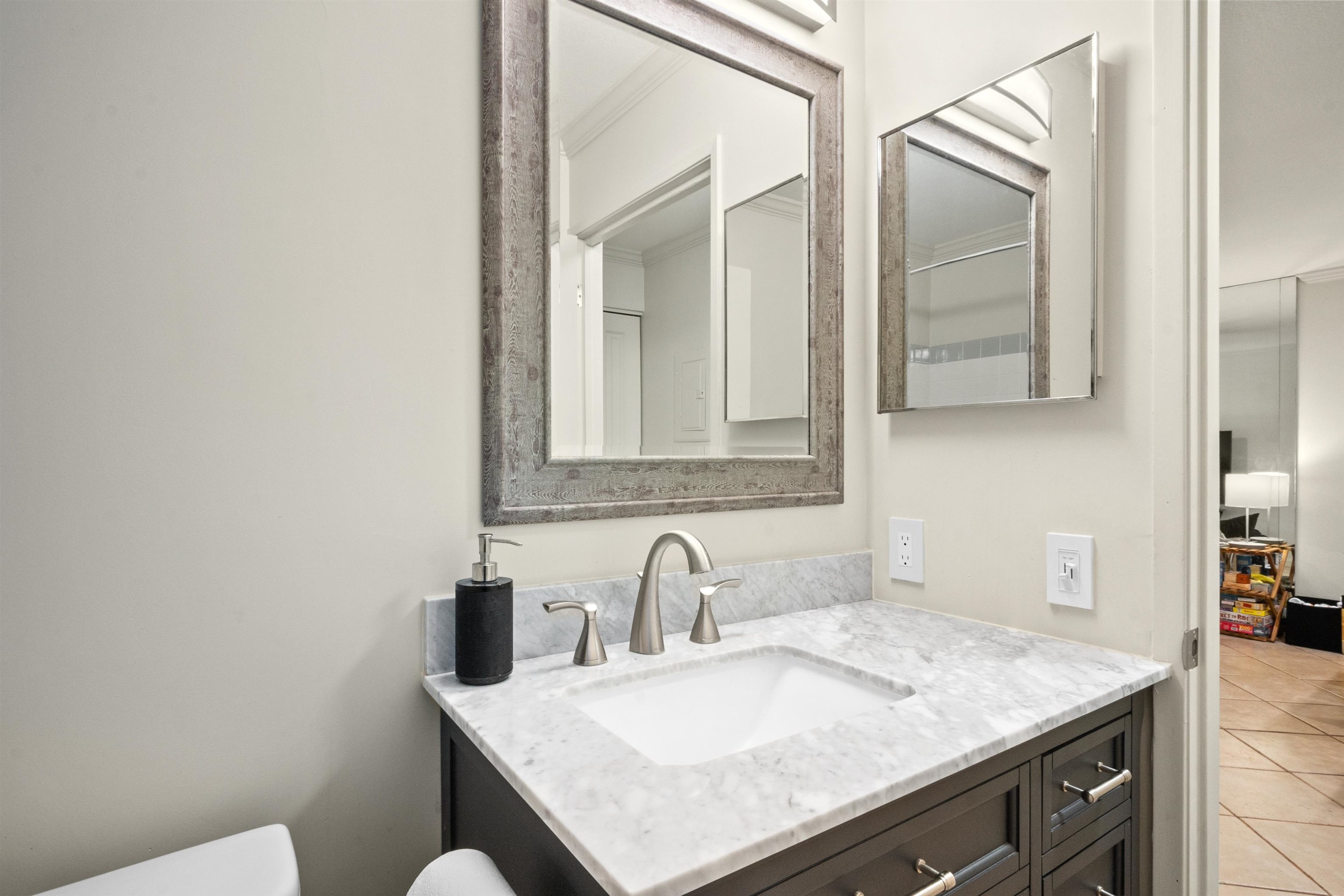 480 Kenolio Road, Unit 15103 Kihei, HI 96753 - Photo 13 of 36 a bathroom with a sink and a mirror