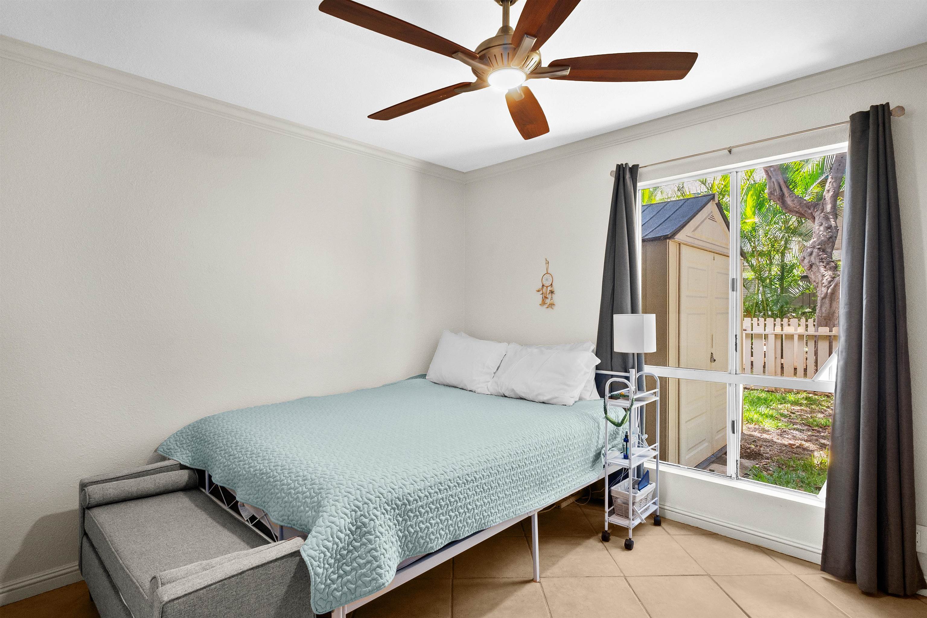 480 Kenolio Road, Unit 15103 Kihei, HI 96753 - Photo 19 of 36 a bedroom with a bed and a window