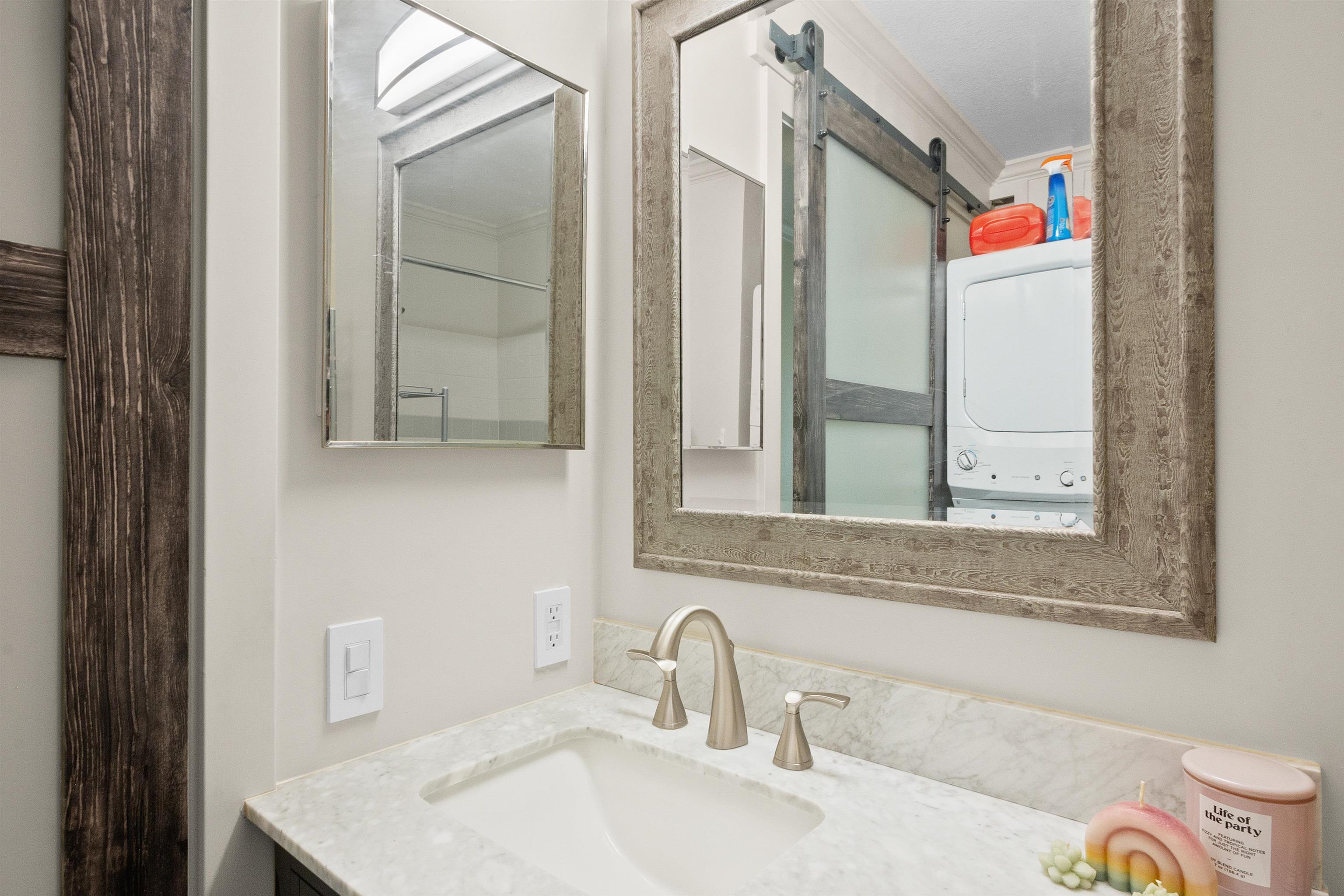 480 Kenolio Road, Unit 15103 Kihei, HI 96753 - Photo 24 of 36 a bathroom with a sink and a mirror