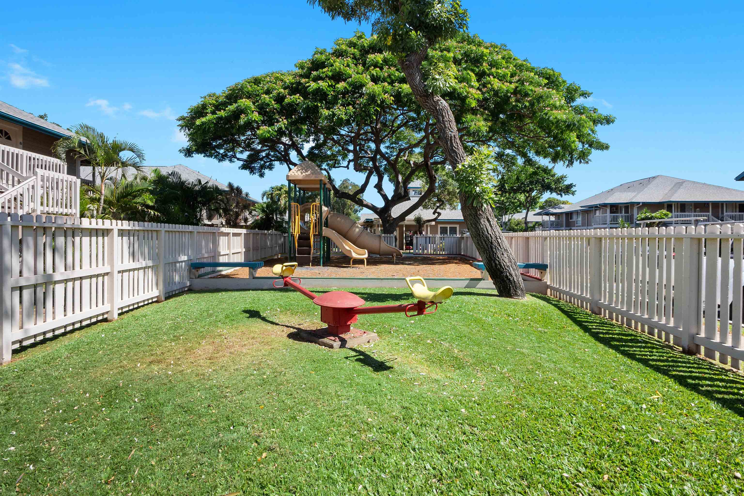 480 Kenolio Road, Unit 15103 Kihei, HI 96753 - Photo 28 of 36 a backyard of a house with table and chairs