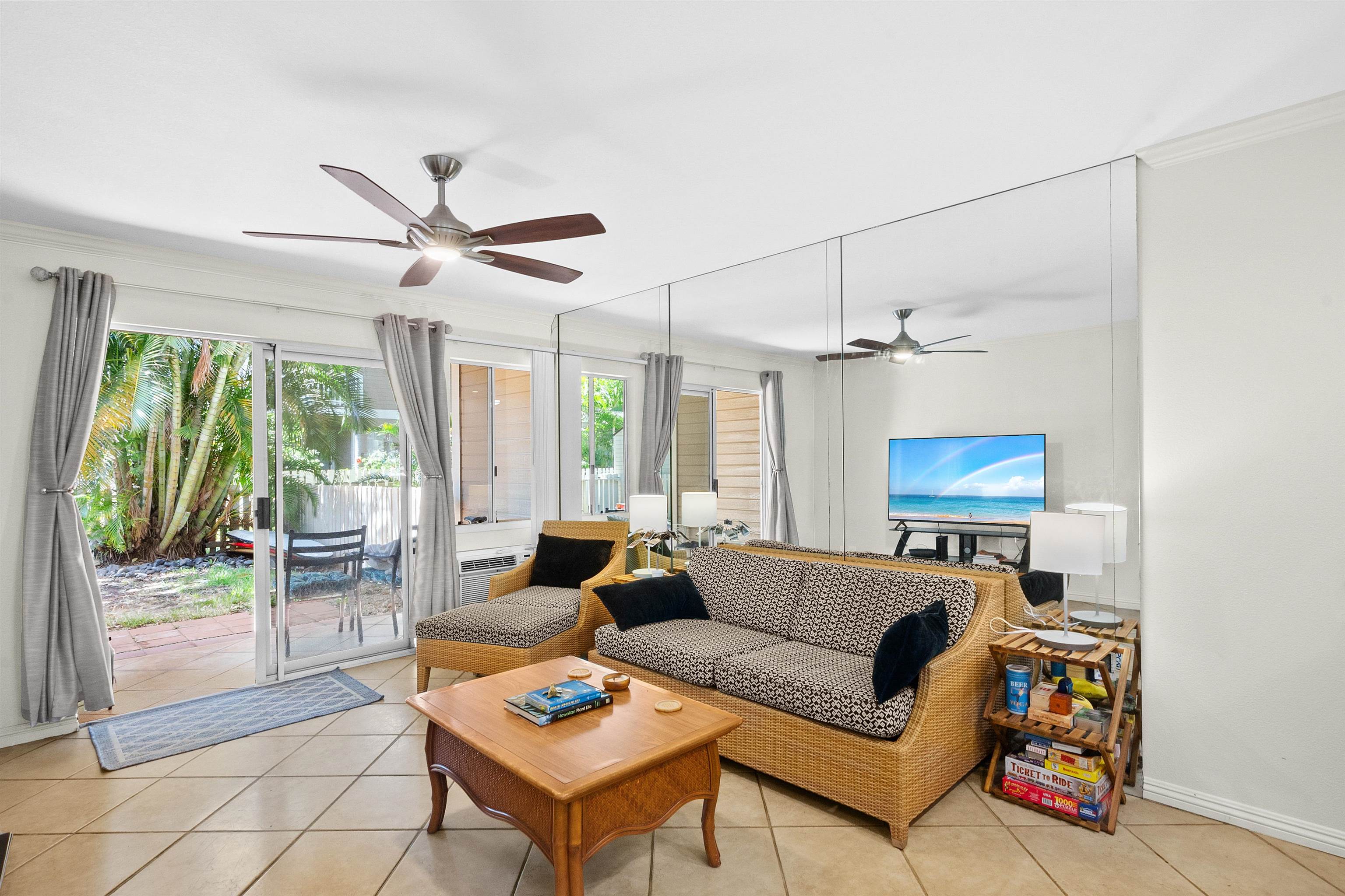 480 Kenolio Road, Unit 15103 Kihei, HI 96753 - Photo 3 of 36 a living room with furniture a ceiling fan and a window