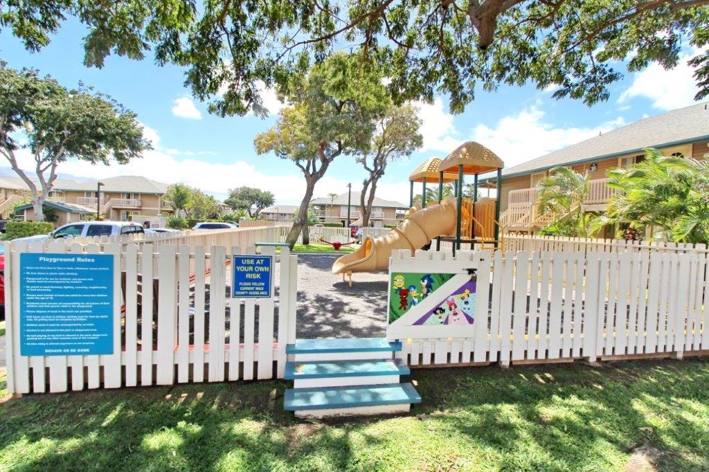 480 Kenolio Road, Unit 15103 Kihei, HI 96753 - Photo 34 of 36 a view of a house with a small yard and a large tree