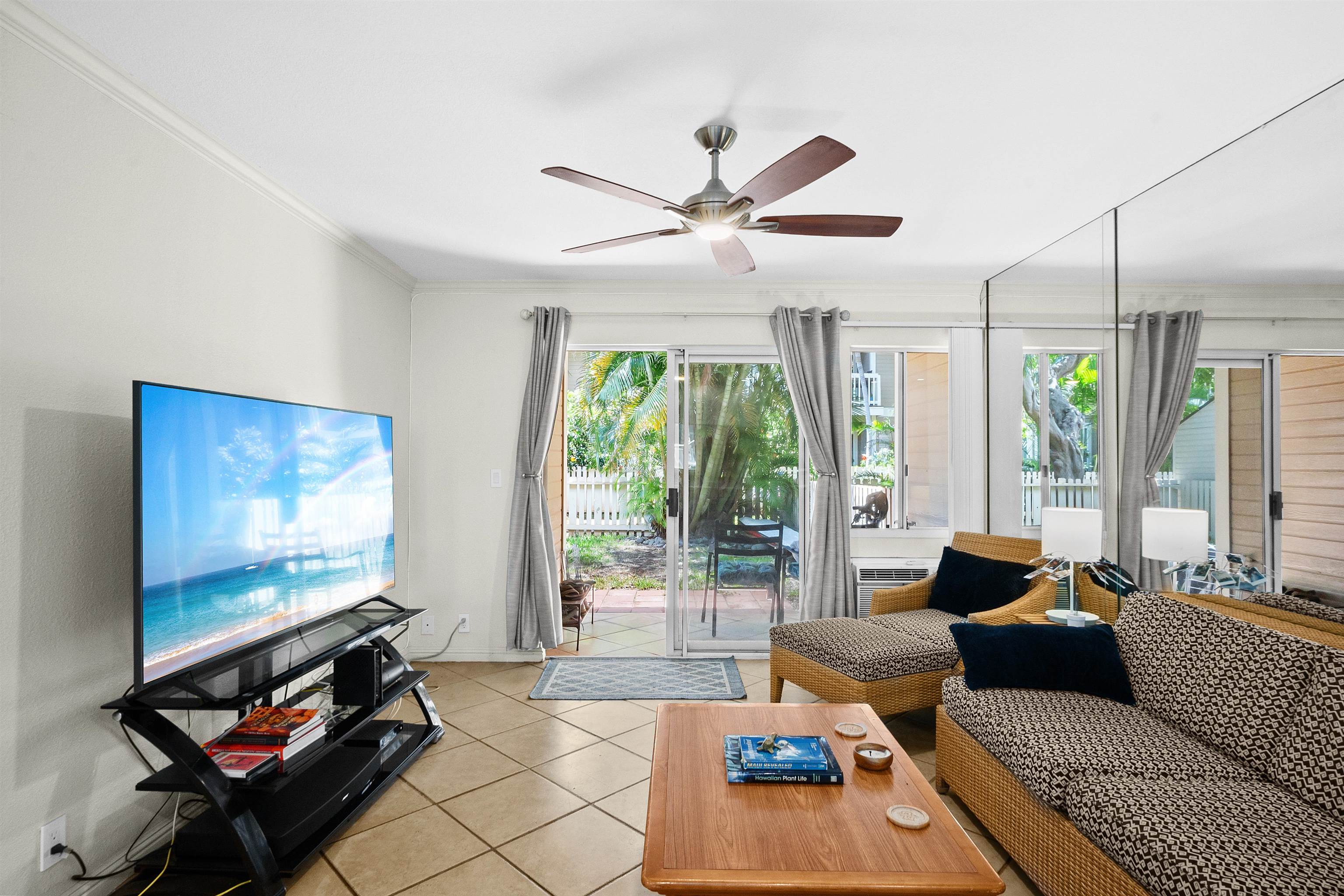 480 Kenolio Road, Unit 15103 Kihei, HI 96753 - Photo 4 of 36 a living room with furniture and a flat screen tv