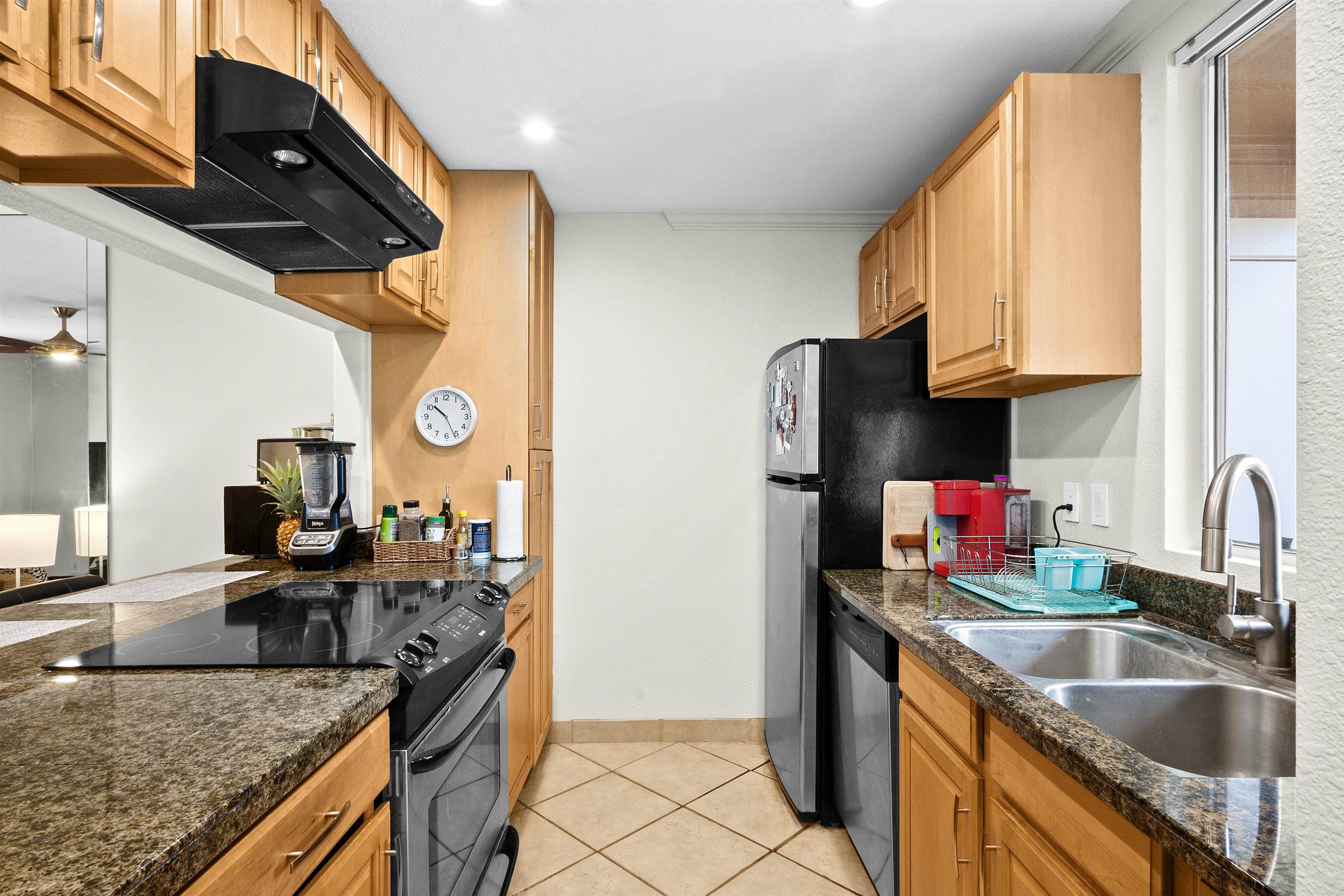480 Kenolio Road, Unit 15103 Kihei, HI 96753 - Photo 9 of 36 a kitchen with stainless steel appliances granite countertop a sink stove and refrigerator