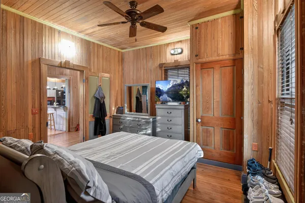 a bedroom with a bed and wooden floor