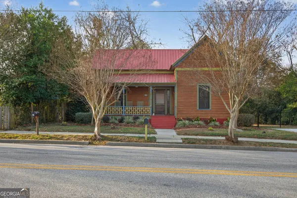a view of a house with a iron fence