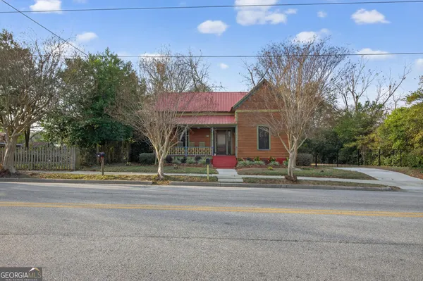 a front view of a house with garden