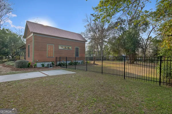 a backyard of a house with table and chairs