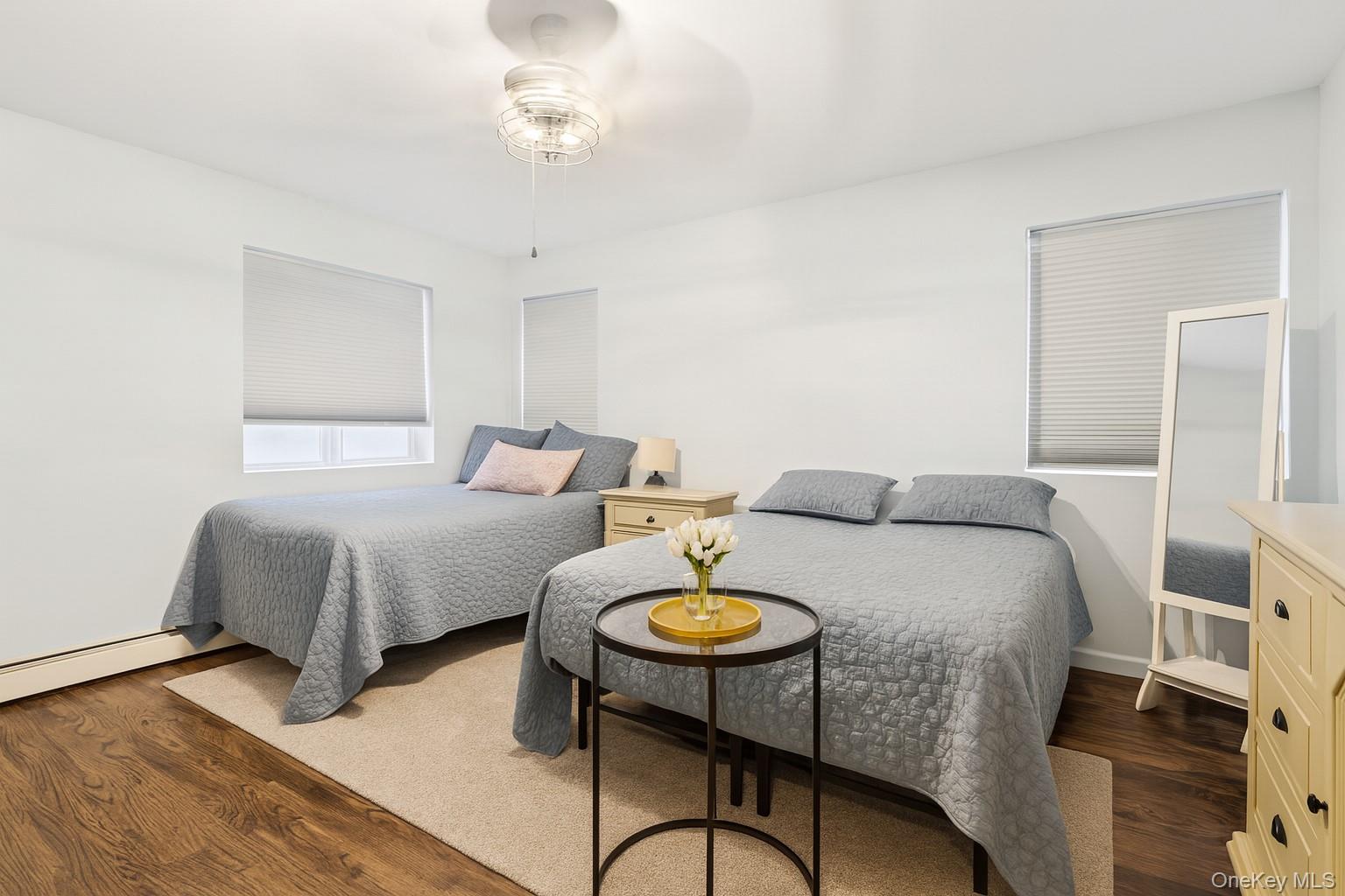 318 East Olive Street, Unit UPPR Long Beach, NY 11561 - Photo 8 of 12 a bedroom with a bed and a table