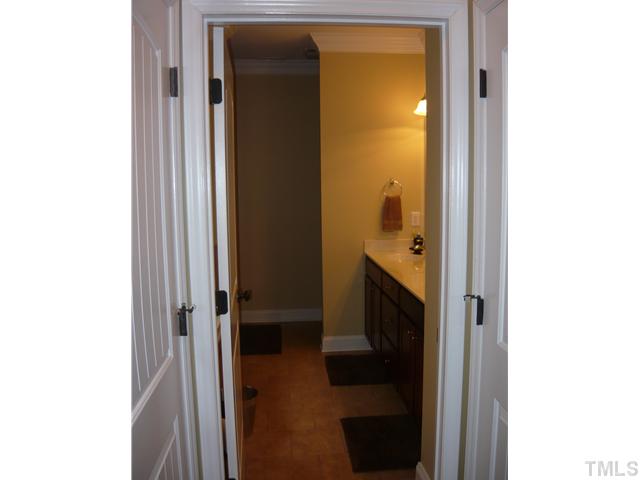 1528 Sedwick Road Durham, NC 27713 - Photo 11 of 18 a en suite bathroom with a sink and a mirror