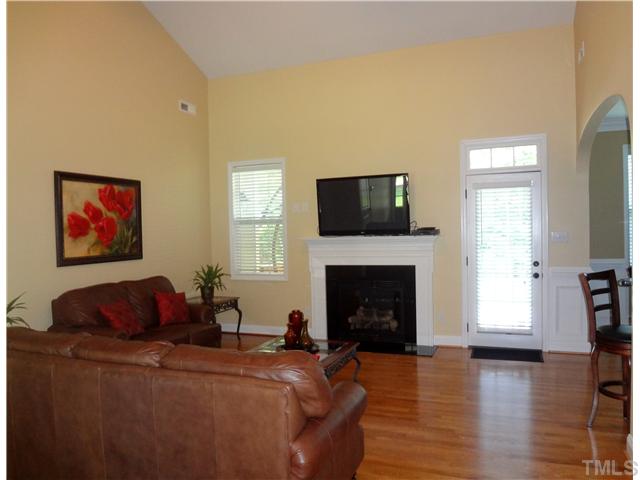 1528 Sedwick Road Durham, NC 27713 - Photo 3 of 18 a living room with furniture a fireplace and a flat screen tv
