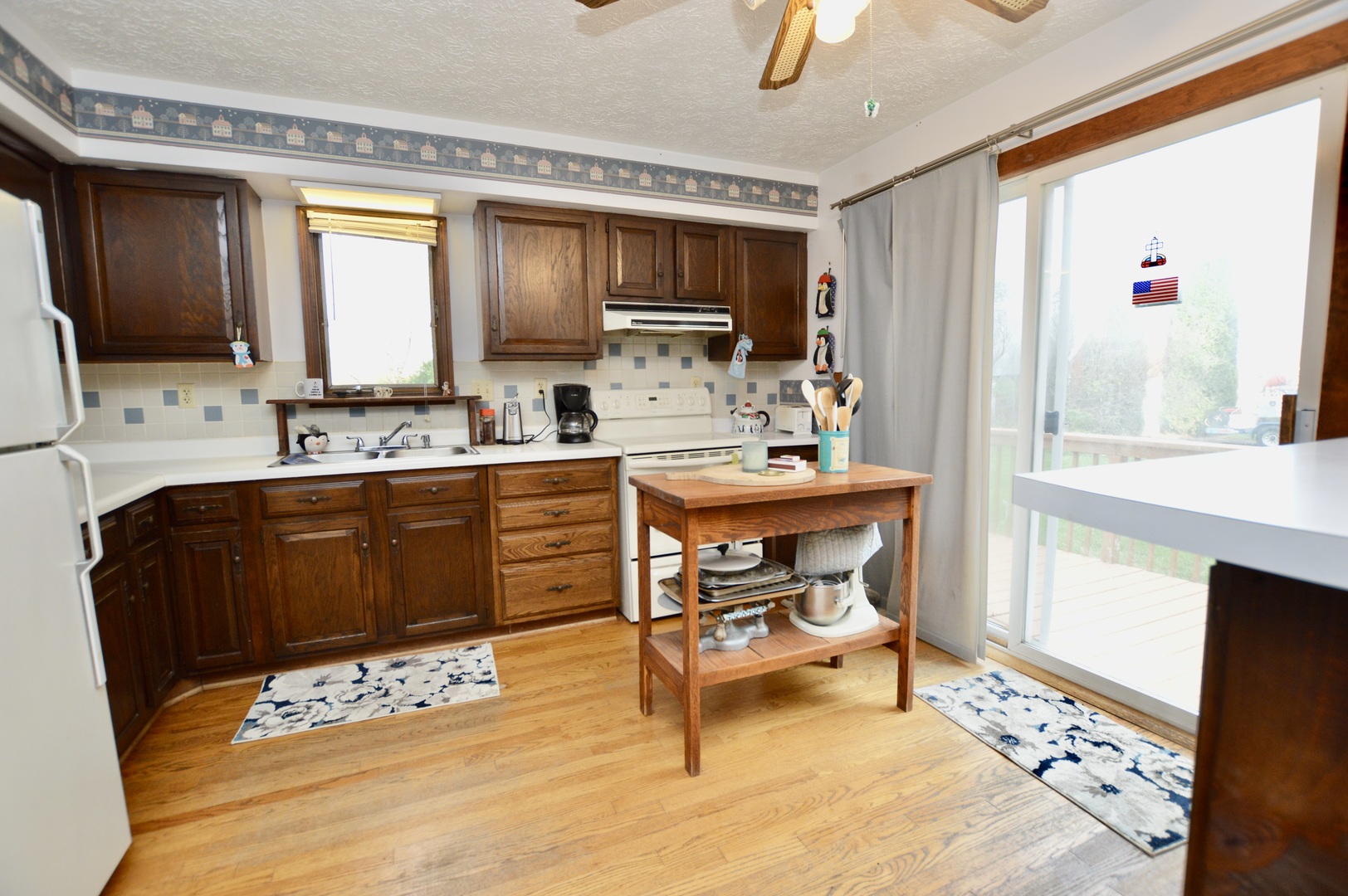 15758 Boone Mc Henry County Line Road Capron, IL 61012 - Photo 14 of 39 a kitchen with a stove a sink and a refrigerator