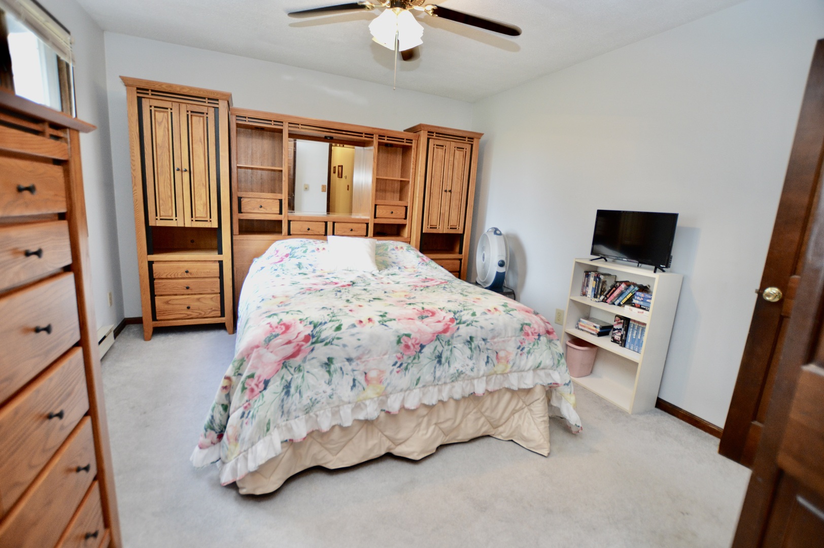 15758 Boone Mc Henry County Line Road Capron, IL 61012 - Photo 20 of 39 a bedroom with a bed a flat tv screen and a dresser
