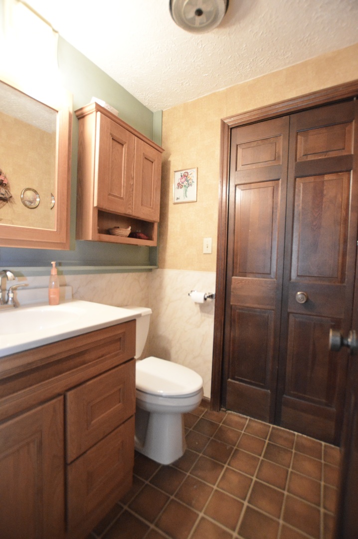 15758 Boone Mc Henry County Line Road Capron, IL 61012 - Photo 26 of 39 a bathroom with a sink a toilet and shower