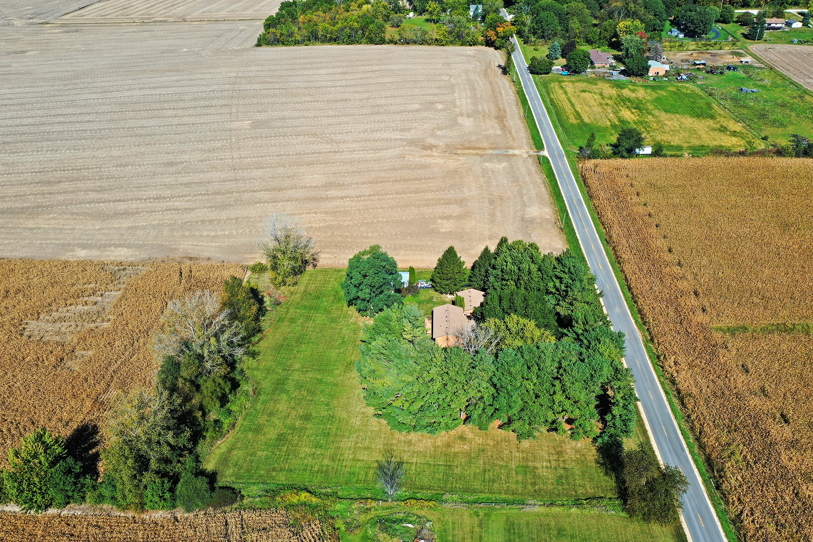 15758 Boone Mc Henry County Line Road Capron, IL 61012 - Photo 34 of 39 a view of a yard with an umbrella