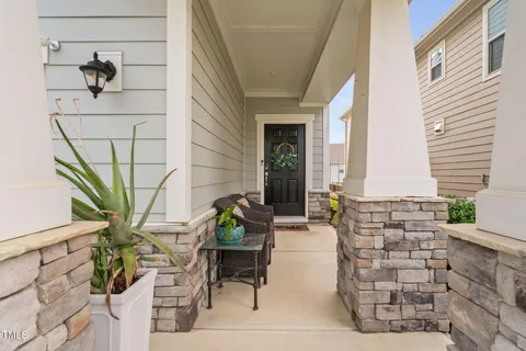 a front view of a house with outdoor seating