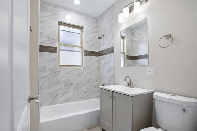 a bathroom with a sink a toilet and mirror