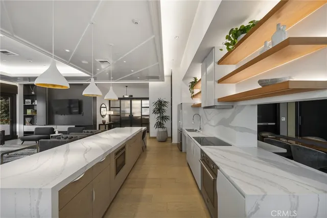 a large kitchen with stainless steel appliances kitchen island a large counter top a stove and a refrigerator