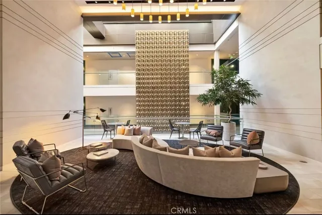 a living room with furniture and a potted plant