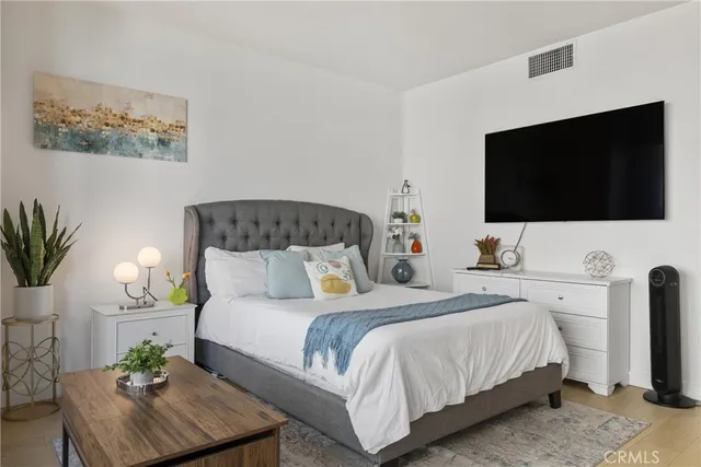 a bedroom with a bed and a flat screen television