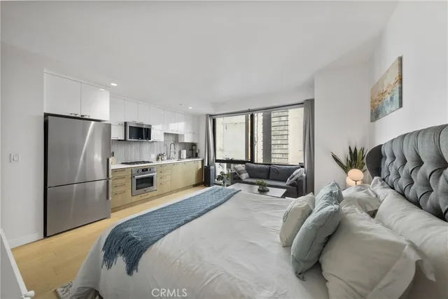 a bed room with a bed a couch and a window