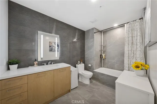 a spacious bathroom with a double vanity sink toilet and shower