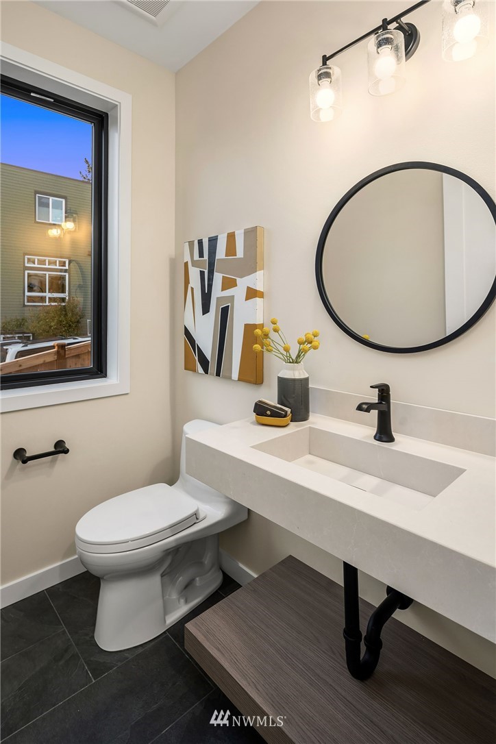 330 3rd Avenue South, Unit B Kirkland, WA 98033 - Photo 14 of 36 a bathroom with a toilet a sink and mirror