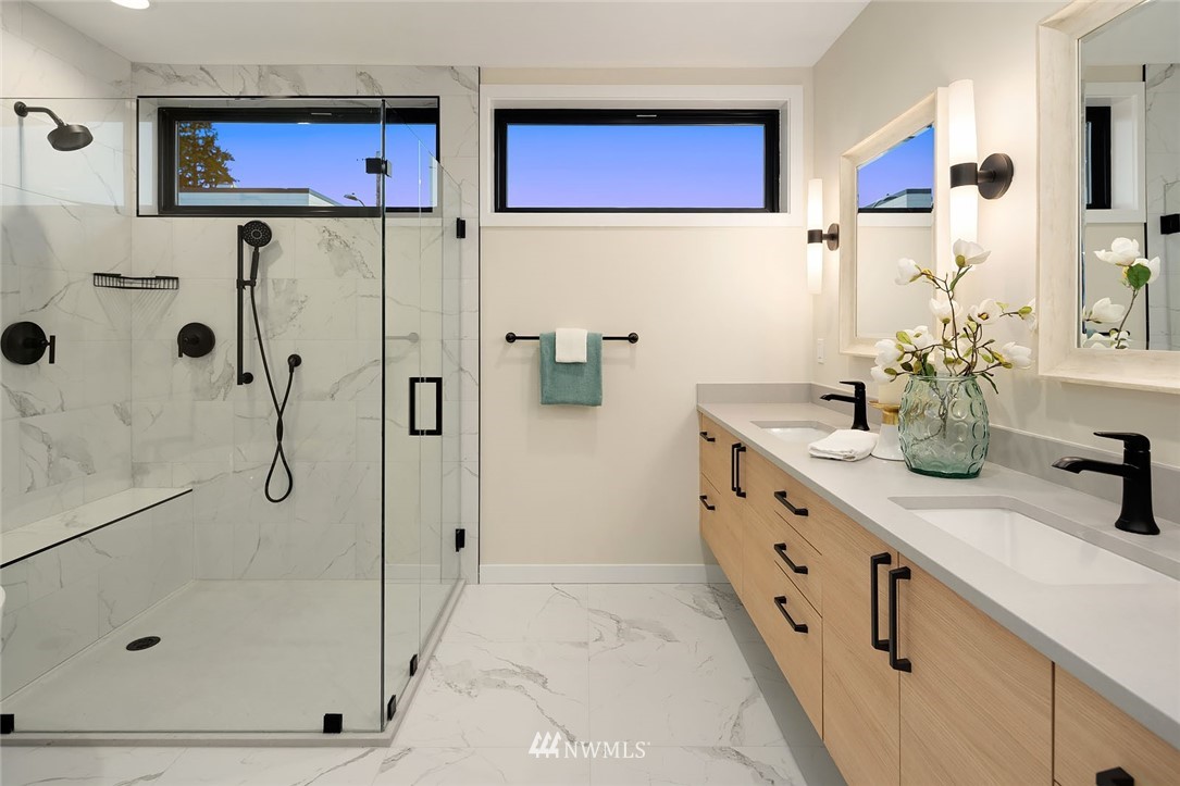 330 3rd Avenue South, Unit B Kirkland, WA 98033 - Photo 16 of 36 a bathroom with a granite countertop double vanity sink a mirror a shower and vanity