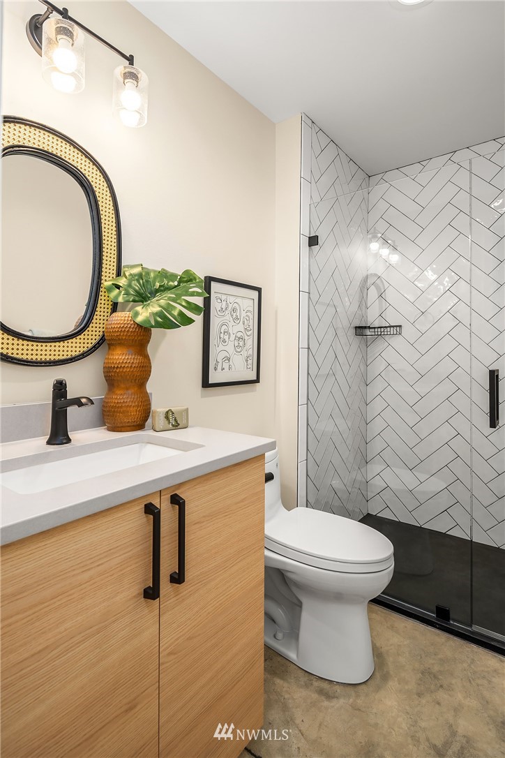 330 3rd Avenue South, Unit B Kirkland, WA 98033 - Photo 24 of 36 a bathroom with a sink a toilet and a mirror