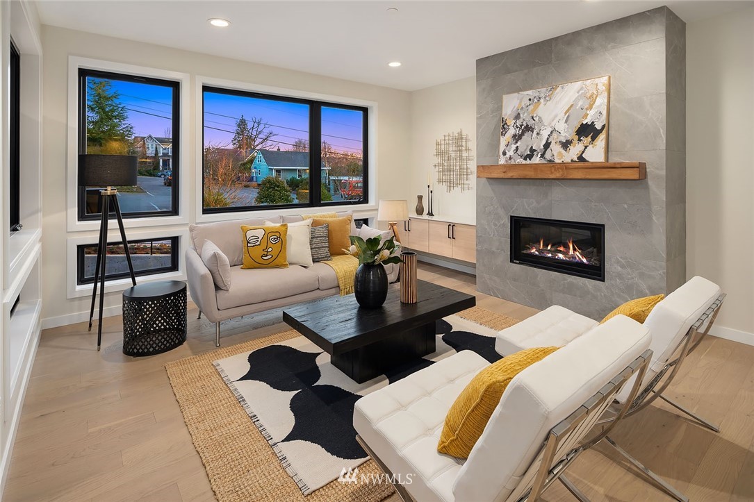 330 3rd Avenue South, Unit B Kirkland, WA 98033 - Photo 3 of 36 a living room with furniture a fireplace and a large window