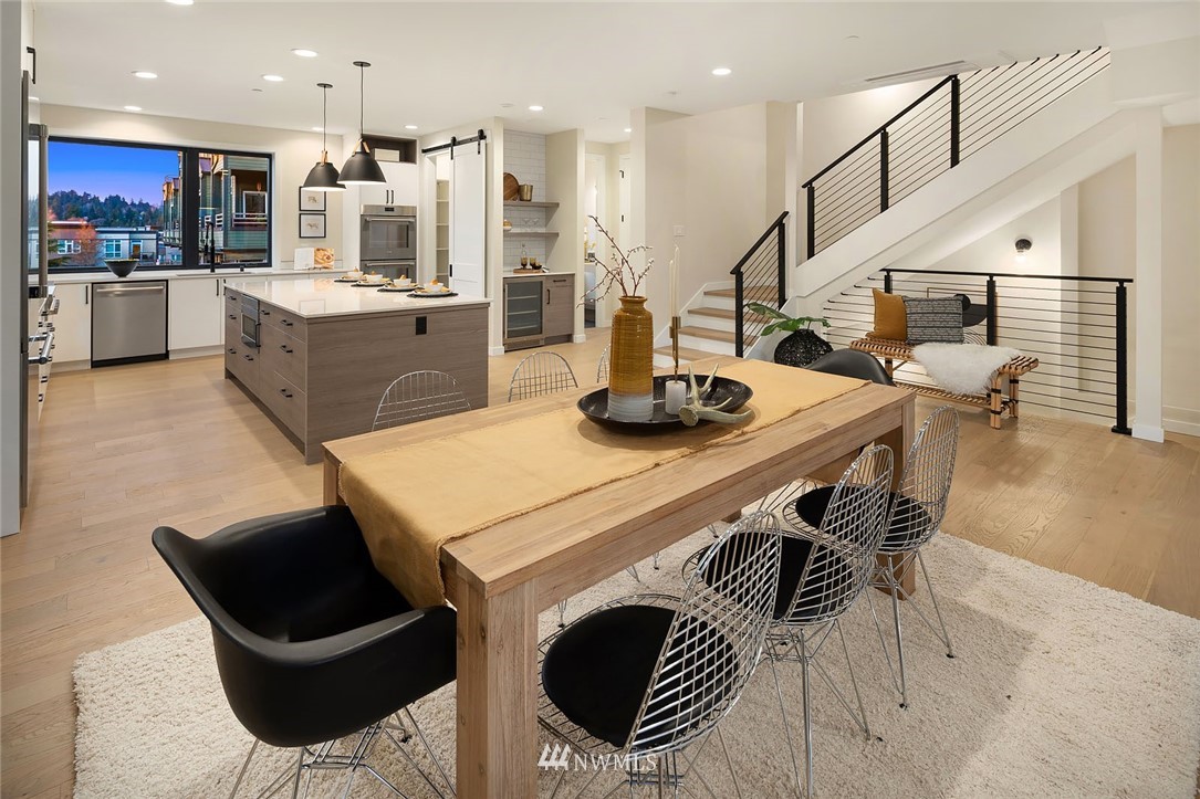 330 3rd Avenue South, Unit B Kirkland, WA 98033 - Photo 7 of 36 a kitchen with stainless steel appliances kitchen island granite countertop a table chairs and a refrigerator