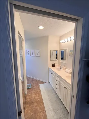 a large bathroom with a double vanity sink and a mirror