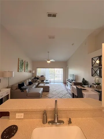 a kitchen with stainless steel appliances kitchen island granite countertop a sink and a stove