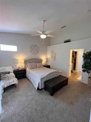 a bedroom with a bed and ceiling fan