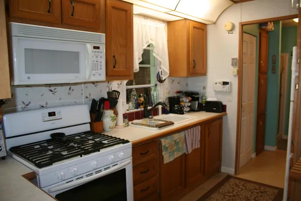 a bathroom with a sink mirror and shower