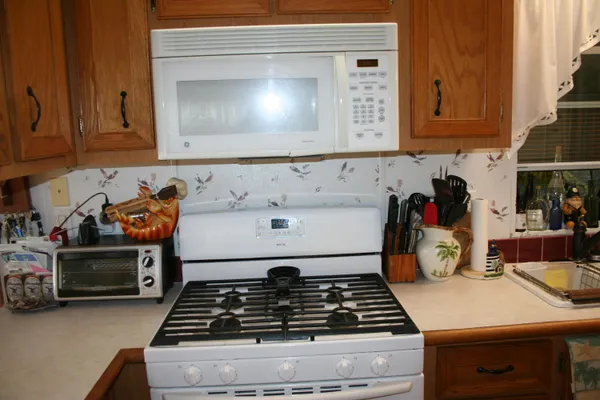 a kitchen with a stove and a white cabinets
