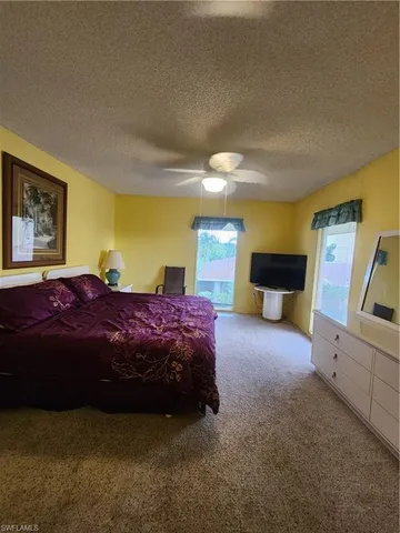 a spacious bedroom with a bed and wooden floor