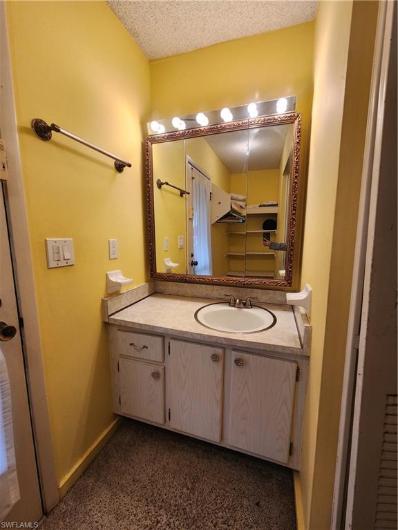 925 Palm View Drive, Unit F120 Naples, FL 34110 - Photo 14 of 25 a bathroom with a sink and a mirror