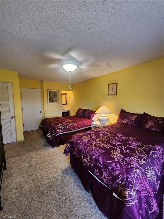 925 Palm View Drive, Unit F120 Naples, FL 34110 - Photo 18 of 25 a spacious bedroom with bed and window