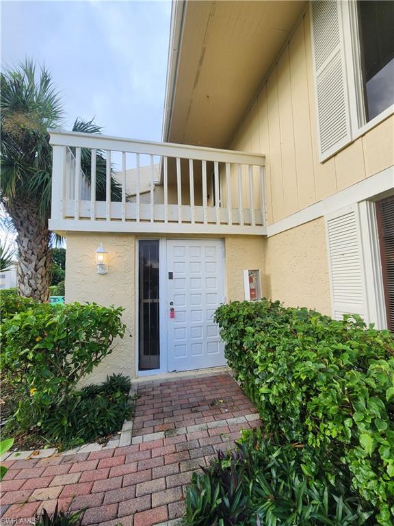 925 Palm View Drive, Unit F120 Naples, FL 34110 - Photo 2 of 25 a front view of a house with garden