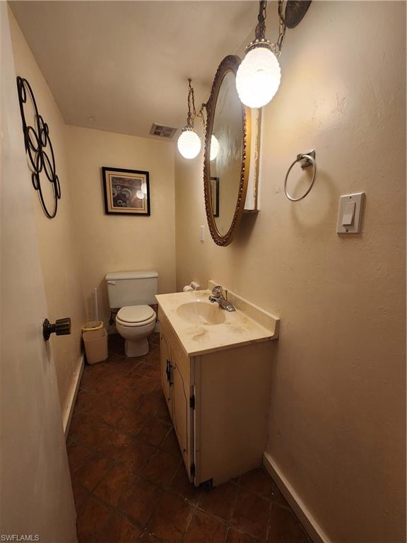 925 Palm View Drive, Unit F120 Naples, FL 34110 - Photo 7 of 25 a bathroom with a toilet sink and mirror