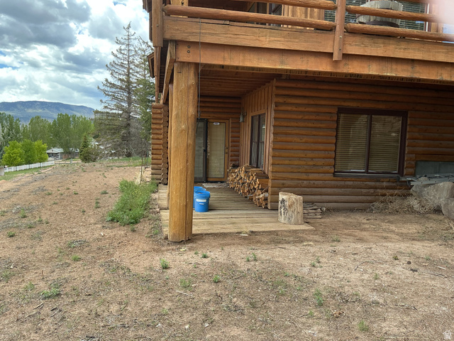 550 State Line Road Manila, UT 84046 - Photo 41 of 41 Log cabin exterior featuring a ground-level deck, upper-level balcony, and natural wood construction