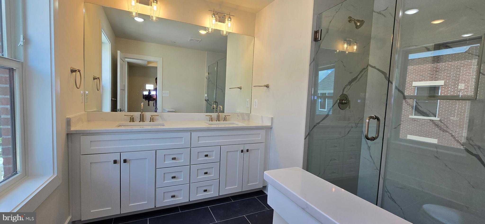 424 Chapel Alley, Unit 7 Frederick, MD 21701 - Photo 25 of 41 a bathroom with a double vanity sink toilet and shower