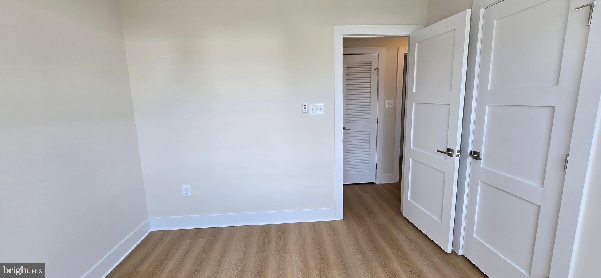 424 Chapel Alley, Unit 7 Frederick, MD 21701 - Photo 29 of 41 a view of a hallway with wooden floor