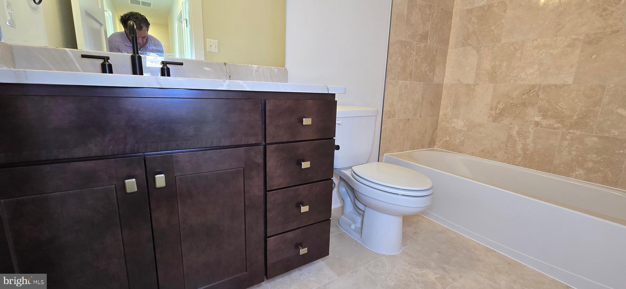 424 Chapel Alley, Unit 7 Frederick, MD 21701 - Photo 32 of 41 a bathroom with a sink a toilet and shower