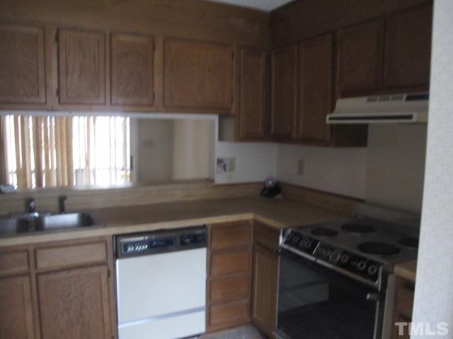 1006 Buckhorn Road Garner, NC 27529 - Photo 4 of 9 a kitchen with wooden cabinets and a sink
