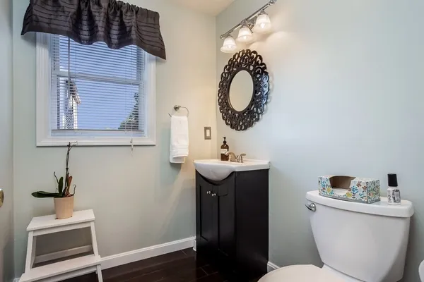 a bathroom with a toilet a sink and mirror